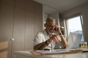 Joyful entrepreneur is having a business call